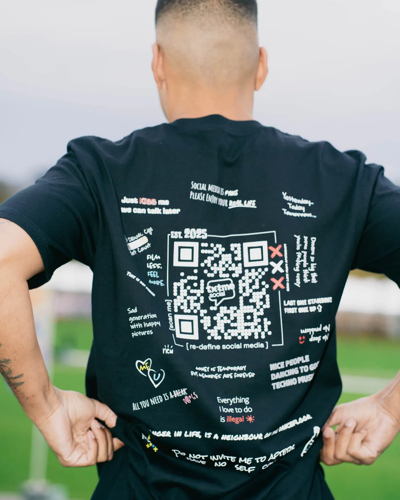 The back of a txtme.social shirt with the code printed on it