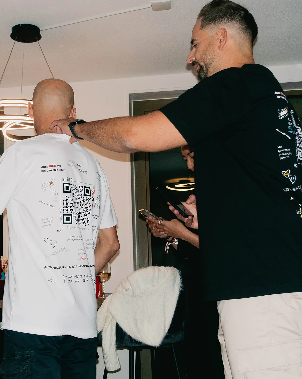 Two friends, one hug, both codes on their backs